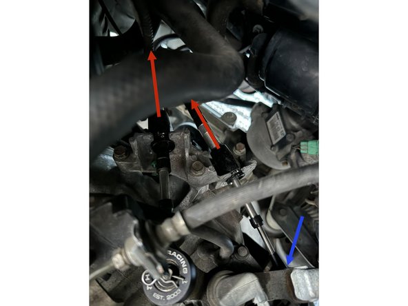 Push the cables (in direction of arrows) into the exhuast tunnel to disconnect them from the bracket.