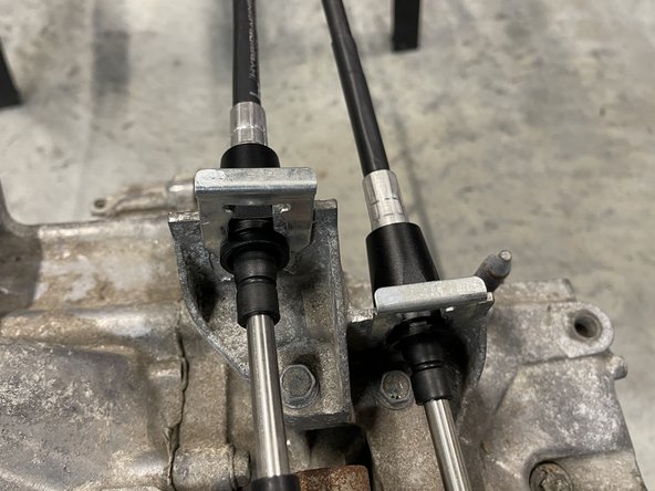 Then, install the cable in the bracket and lock it in place using a spring C clip.