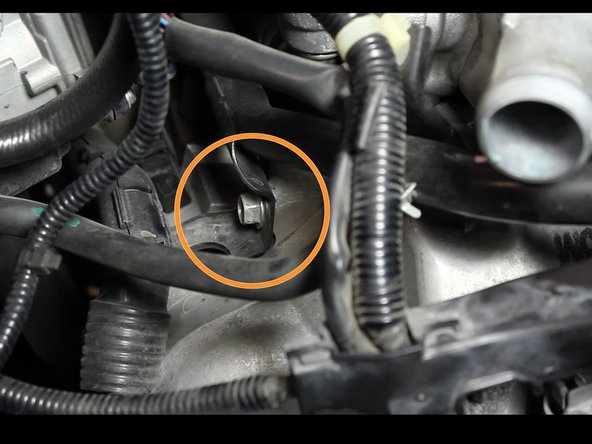 Re-install the heater hose pipe mounting bracket.