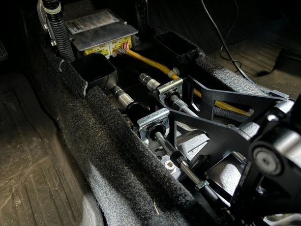 Using a 5lb hammer, tap the cable clips into place on both shifter and transmission.