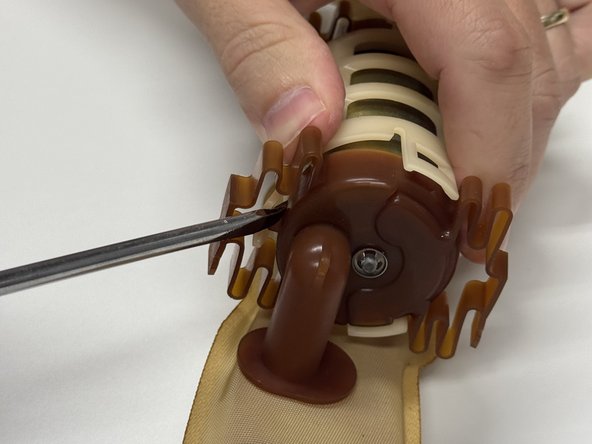 Unclip and remove the pump holder. This will separate the pump and filter from the outer cage.