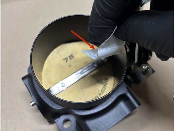 Goal: Ensure the throttle plate and bore are completely clean before applying Super Seal.