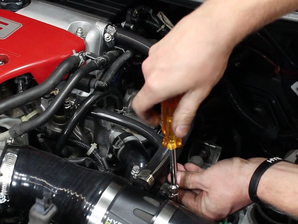 Install and tighten the second vacuum hose.