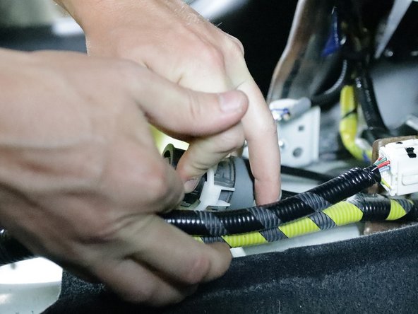 Repeat step 13 on the right-side cable. Spin the lock, slide it out and let it spin back once it is off the shifter. Keep this in mind as you will need to use the same technique to install them onto the new shifter.