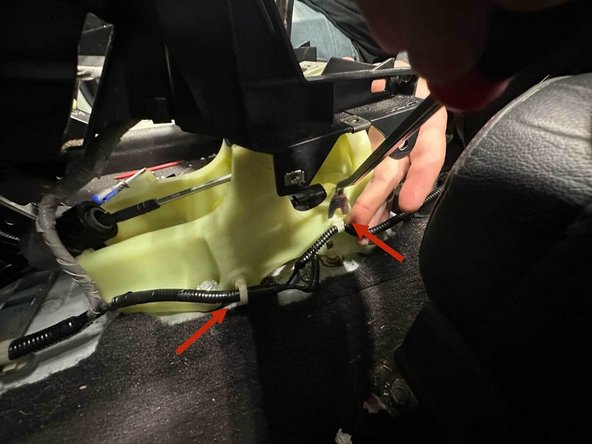 Using a panel popper, remove all of the wiring harness clips attached to the shifter plastic.