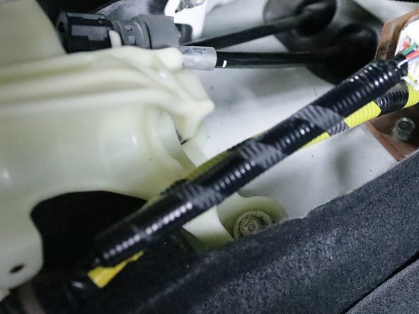 Use a 12mm socket and remove all four bolts that hold the shifter in place. Remove the shifter from the car.