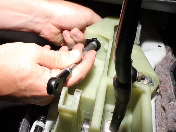 Once the clip is removed, push the cable inward and slide it away from the shifter.