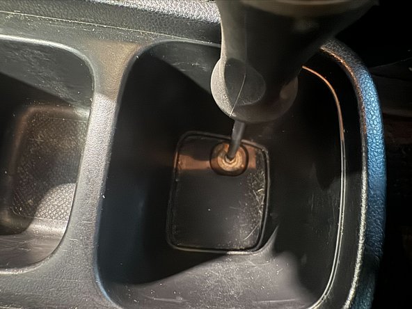 Tighten the bolt in rear cavity of console.