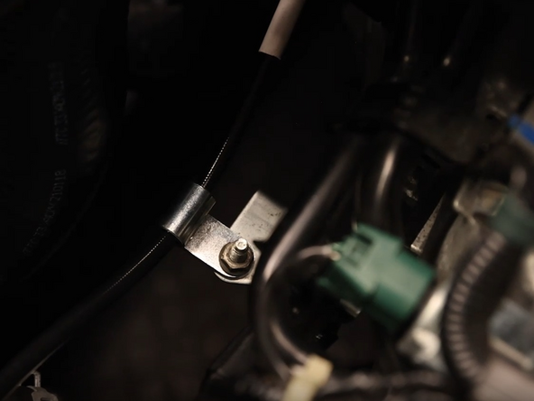 Secure the clutch line bracket to the OEM mounting location on the front of the transmission.