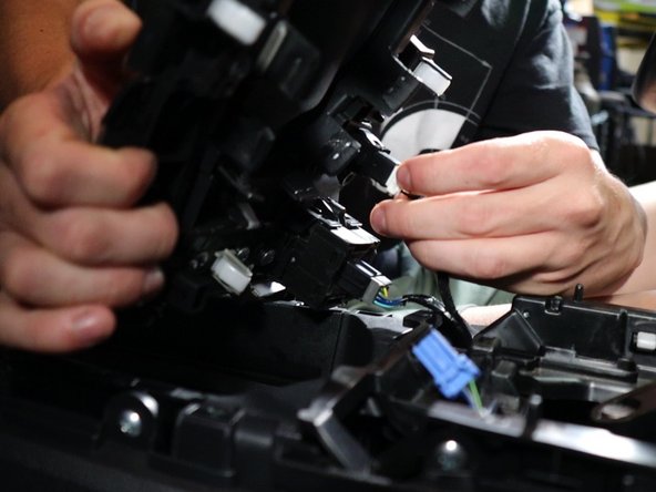Lift the shift boot cover upwards and unplug all of the electrical connectors.