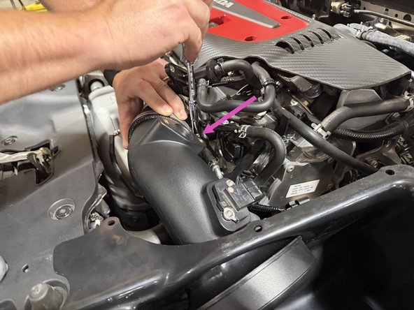Snug is enough. There is no torque spec, and over-tightening a worm clamp on silicone will cut the coupler.