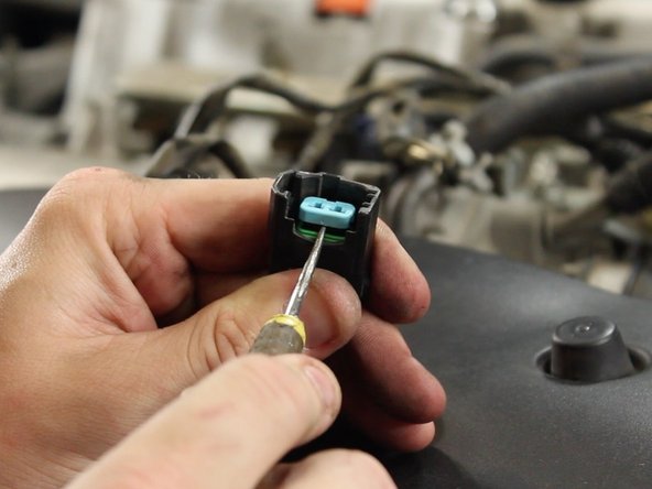 Using a small flat tip screw driver or pick tool, remove the pin lock inside of the OEM fuel injector connectors. (qty 4)