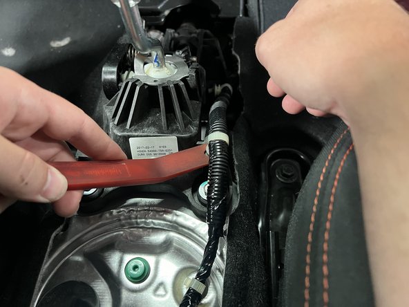 Remove the factory wiring harness from the stock shifter assembly.