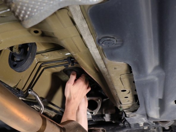 Pull downward on the shifter cable seal and this will remove the cables from the chassis.