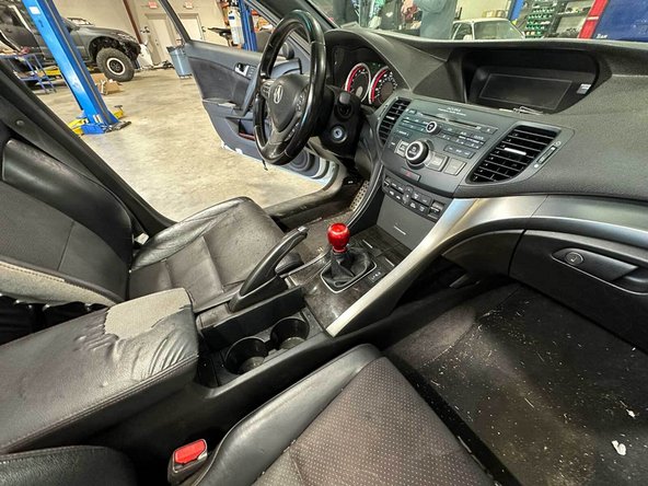 Wrap the knob in a microfiber towel and spin it counter-clockwise 10-15 turns; loosen the 14 mm lock-nut first if fitted.