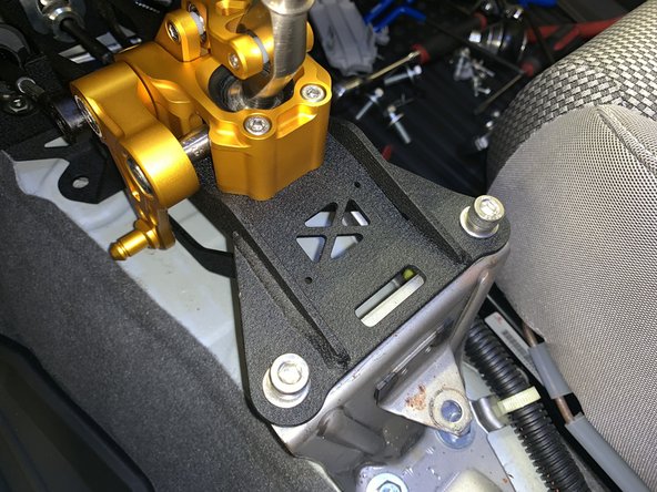 Install the Hybrid Racing shifter and use the supplied bolts to mount it directly to the chassis. It does not use any sort of base bushing.