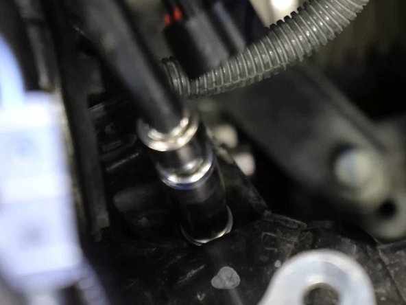 Unbolt the wiring harness and move it out of the way, exposing the shifter cables and bracket.