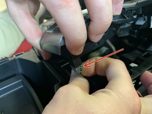 Unplug the drive mode selector as well as the parking brake and brake hold button.