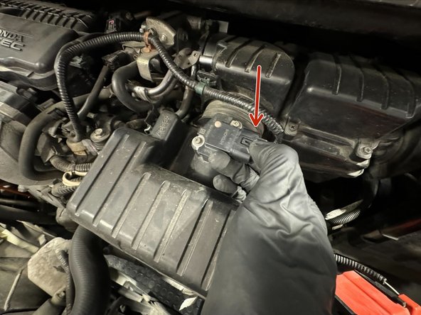 Unplug MAF connector. Release latch on connector by pushing down on the tab.