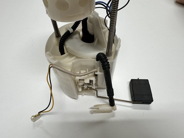 Slide the pump assembly into the housing. Be sure to secure all clips around the top of the case.