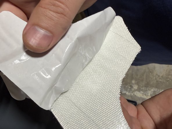 Peel the backing carefully and press it into the spot outlined on the intake box.