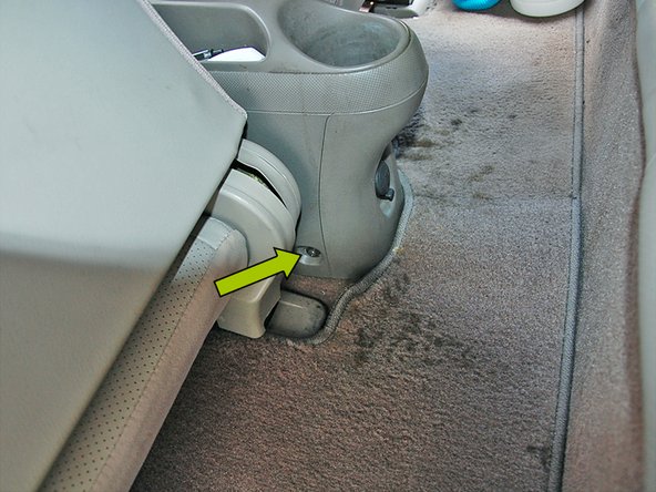 Slide both front seats forward to reveal the final (2) screws holding the center console in. Using the same Phillips head screw driver remove each screw.