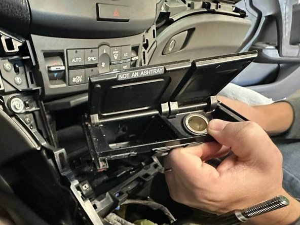 Pull the coin tray mount out just enough to remove the connectors from the mount, then entirely remove the mount.