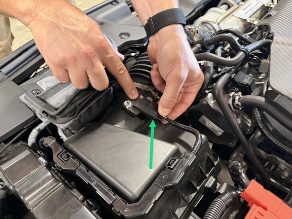 Unplug the MAF sensor connector at the air cleaner cover and lay the wiring over the front of the car, as shown in the third photo.