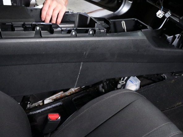 Lift the console up and slide it backward. Remove it from the car.