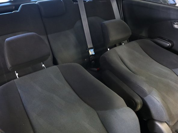 Fold the seats back so it is easier to remove the console.