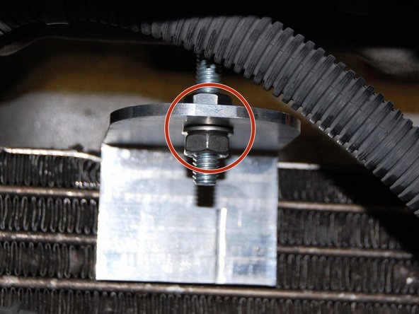 You can now install the EK condenser. Using the supplied brackets and hardware, secure it to the top. If you remove the lower tabs, use the replacements supplied with this kit.