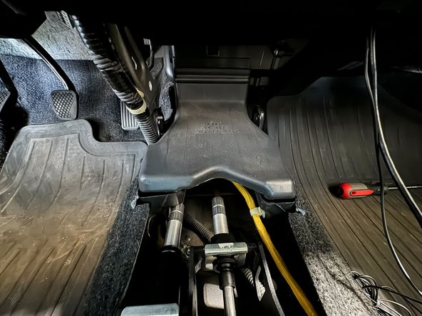 After removing the console, remove the A/C duct. This will give you a better line-of-sight to the cable chassis grommet.