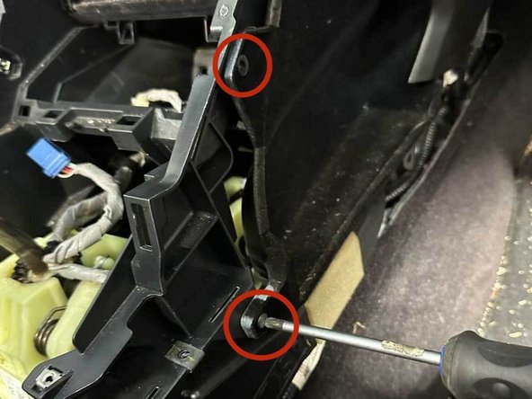 On the passenger side remove the two screws that hold the inner pocket to the console.