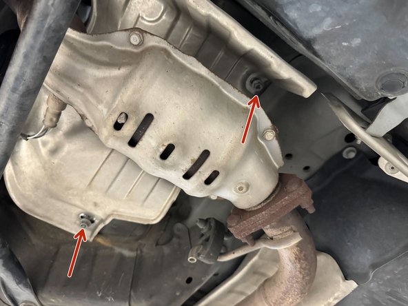 Complete heat shield install by tightening remaining x2 10mm nuts.