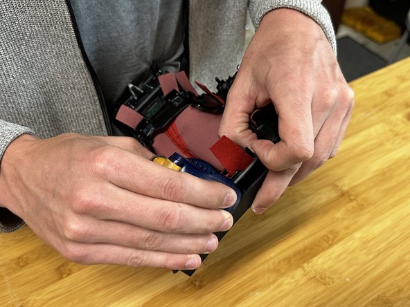 Use a general-purpose stapler to secure the fabric to the factory plastic tabs. Small staplers work great since they are easy to hold and maneuver.