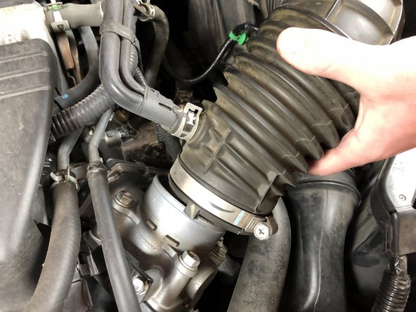 Unsnap the airbox cover and remove it completely from the car.