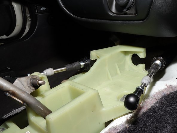 Remove the spring clip, and like the previous side, push the cable in and slide it away from the shifter.