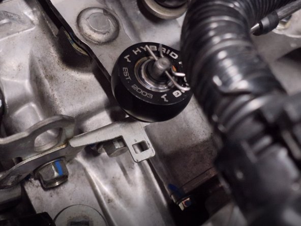 Remove the wire harness from the bracket on the front of the transmission.