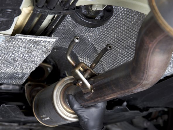 Pull downward to disconnect the exhaust and remove it from the car.