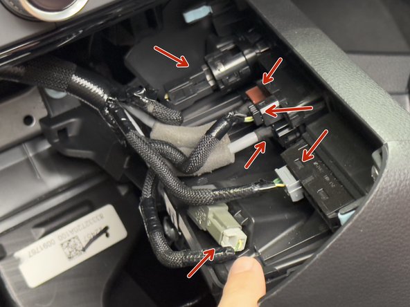 The back of the console cover holds USB ports, and other misc connections. Remove all so you can remove the console from the car.