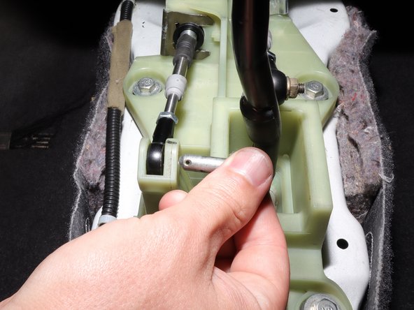 Remove the clip, then slide the pin out.