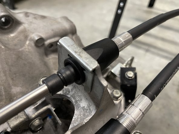 Then, push the shifter cable through the shifter cable bracket and secure it with the supplied C clip.