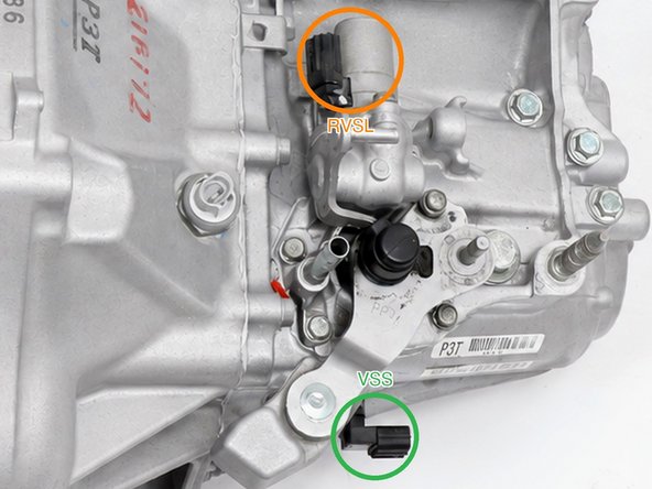 Connect the included VSS sub-harness to the transmission speed sensor connection: on the K20 final-drive VSS that is an in-line connector clipped into a bracket at the lower edge of the case, not a plug on the sensor body (VSS ring, shown close up in the third photo). Tie the sub-harness up so it cannot hang loose.