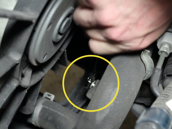 Remove the lower radiator hose bracket.
