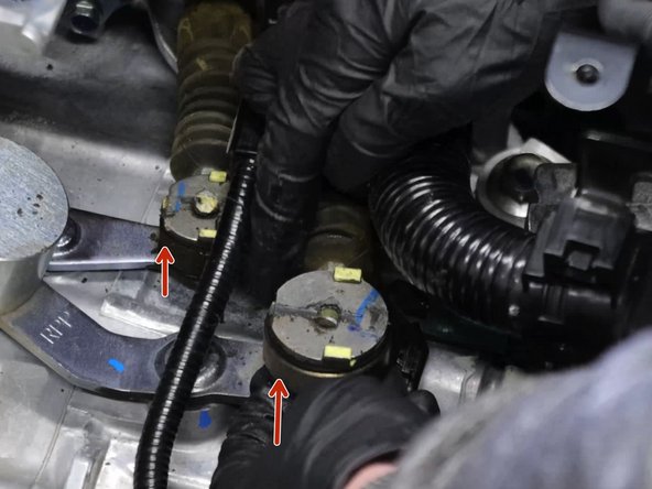 Remove the shifter cable retaining clips.