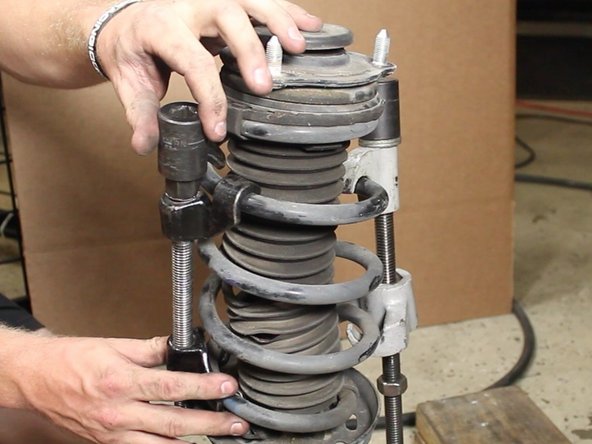 Use a spring compressor to hold the spring in place.