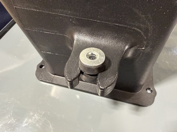 Install the rubber isolation grommet into the back of the intake. Make sure the ridge or lip on the grommet faces down, then insert the sleeve to hold it in place.
