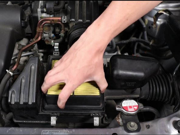 Remove the air box lid and then remove the air filter.