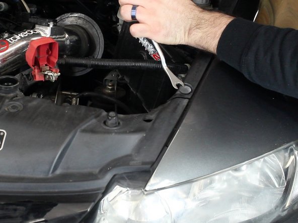 Remove the clips that attach the upper grill cover.