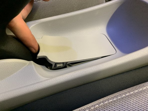 Remove the trim beneath the e-brake handle.